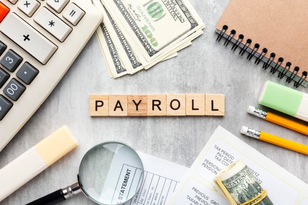 payroll services 3 top view payroll concept with items Best Accounting and Tax Consultant in Dubai | Profitrack